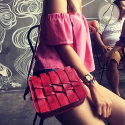 Túi đeo chéo màu đỏ với kiểu dáng đan vào nhau trước mặt túi lạ mắt